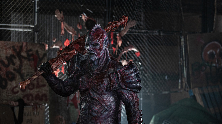 Matthew Ninaber as Psycho Goreman with a club over his shoulder in PG: Psycho Goreman