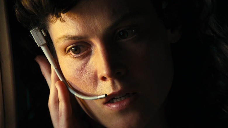 Sigourney Weaver's Ellen Ripley listens to her headset in Alien
