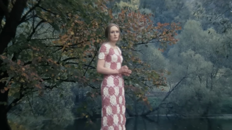 Olga Barnet as Kelvin's Mother stands in a forest in Solaris