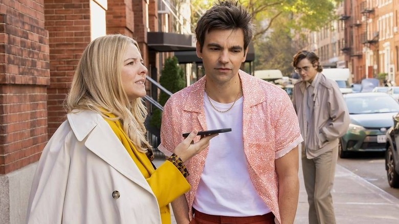 Brooke and Cary on the phone on the street in The Other Two