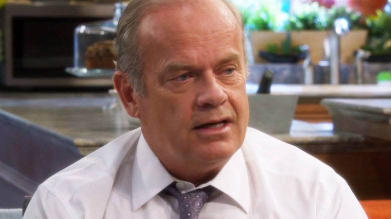Kelsey Grammer's Allen Braddock looks off to his left as he sits on a couch in Partners