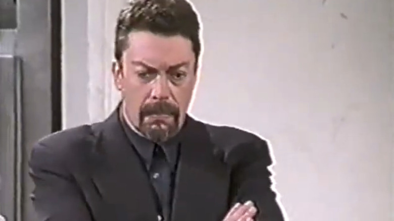 TIm Curry's Simon Ferguson folds his arms in Over the Top