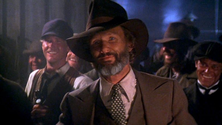 James Averill smiling among a small crowd in Heaven's Gate