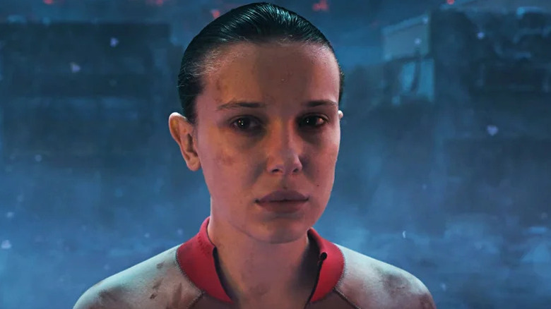 Millie Bobby Brown's Eleven covering looking sad and serious on Stranger Things