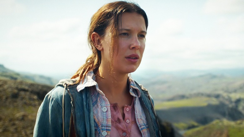 Millie Bobby Brown's Eleven looking serious while standing outdoors on Stranger Things