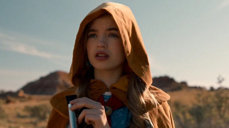 Nell Fisher's Holly Wheeler wearing a hooded cloak on Stranger Things