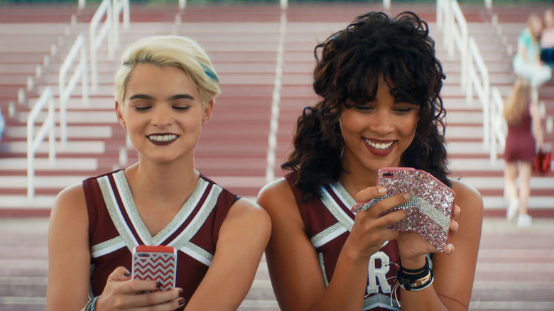 cheerleaders texting on the field