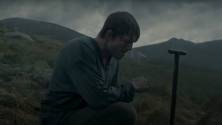 Peter Claffey as Ser Duncan the Tall kneeling by a gravesite in A Knight of the Seven Kingdoms