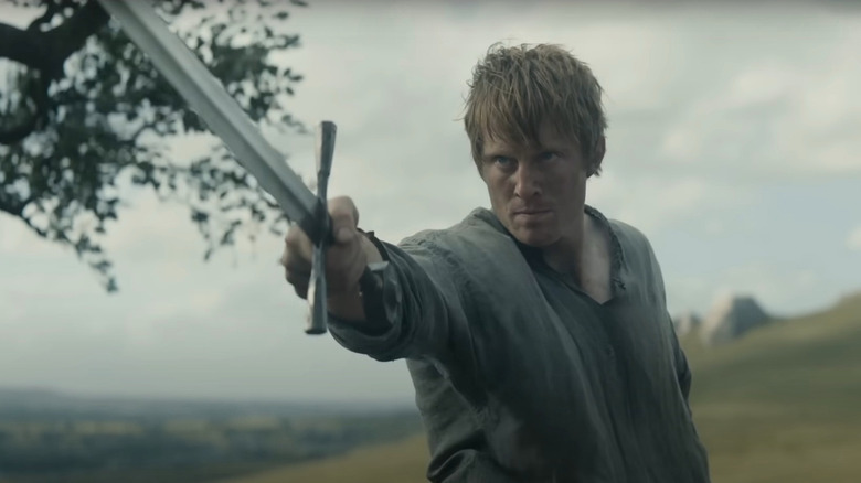 Peter Claffey as Ser Duncan the Tall wielding a sword in a fighting stance in A Knight of the Seven Kingdoms