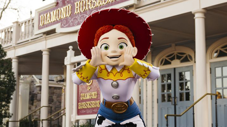 Jessie stands in front of the Diamond Horseshoe