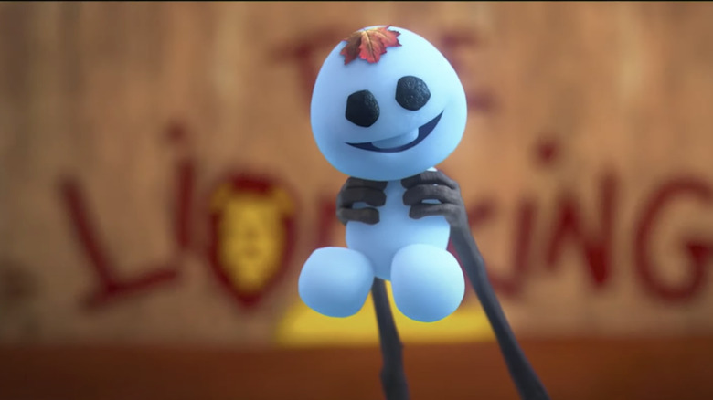 Olaf holding up a Snowgie for The Lion King
