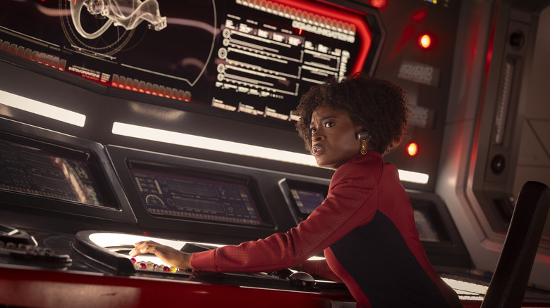 Celia Rose Gooding as Uhura seated at her station with a concerned look on her face in Star Trek: Strange New Worlds