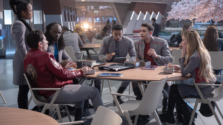 Kerrice Brooks, Romeo Carere, Karim Diané, Sandro Rosta, George Hawkins, and Bella Shepard as various cadets seated around a cafeteria table in Starfleet Academy