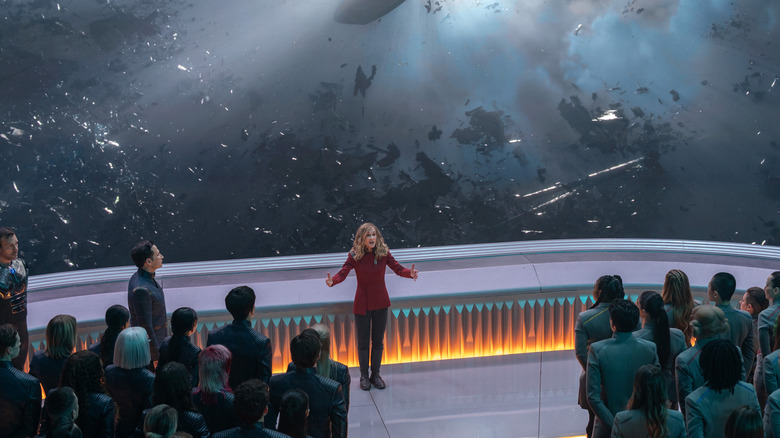 George Hawkins, Kerrice Brooks, Joseph Messina, and Sandro Rosta as cadets watching Holly Hunter as Nahla Ake delivering a speech in Starfleet Academy
