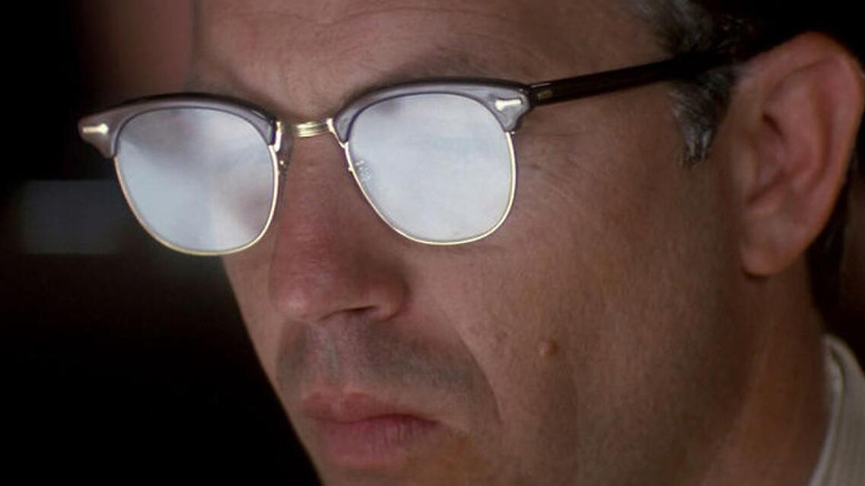 Jim Garrison's glasses reflect light in JFK