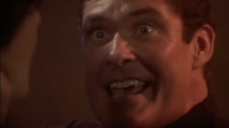 David Hasselhoff's Mitch Buchannon is seen smiling maniacally in closeup in Baywatch Nights