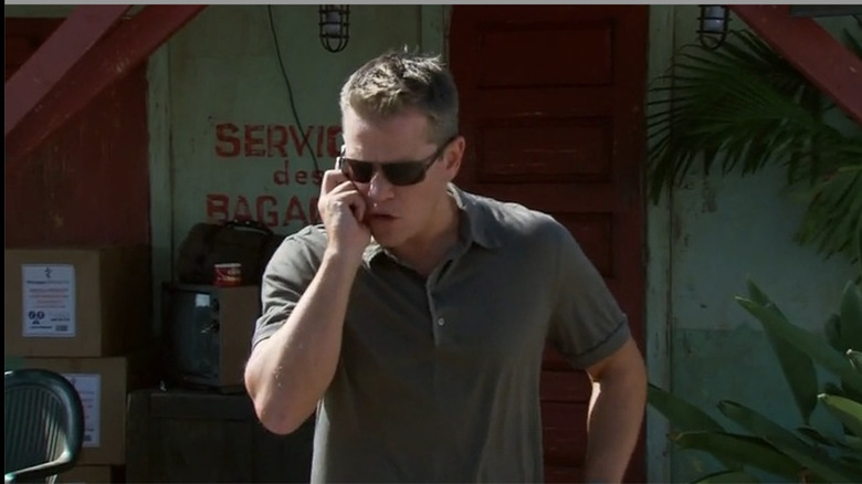 Matt Damon yells into his cellphone while wearing sunglasses and a grey polo in "Entourage"