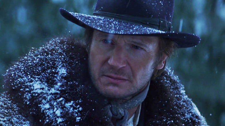 Liam Neeson as Colonel Carver standing in the snow in Seraphim Falls
