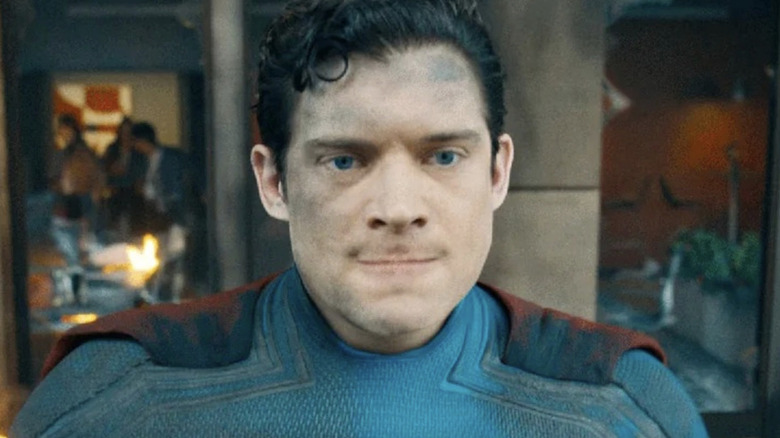 David Corenswet hovers in front of a damaged building in Superman
