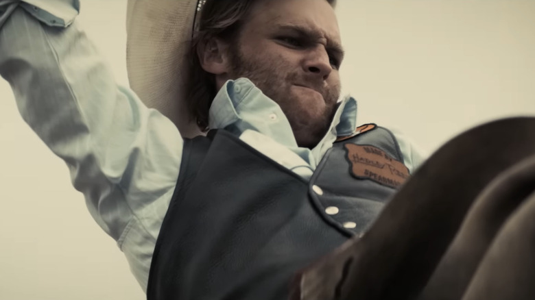 Wyatt Russell's True Brandywine is seen grimacing as he rides a bronco in Broke