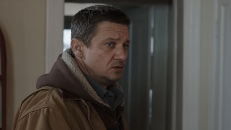 Jeremy Renner's Cory Lambert stands in a living room in Wind River