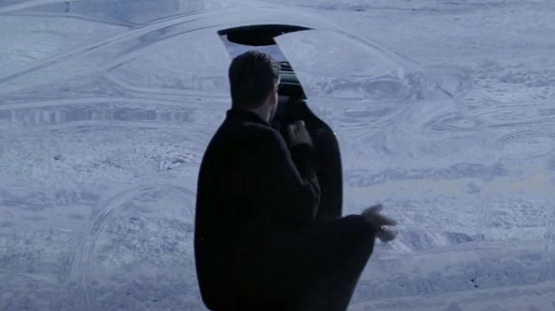 Pierce Brosnan's James Bond opens the door of an invisible Aston Martin in Die Another Day