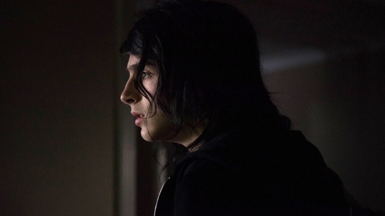 Timothée Chalamet as Stephen Elliott sitting in a dark room in The Adderall Diaries