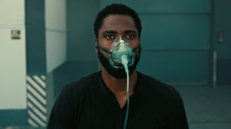 John David Washington as The Protagonist with the mask on his face in Tenet