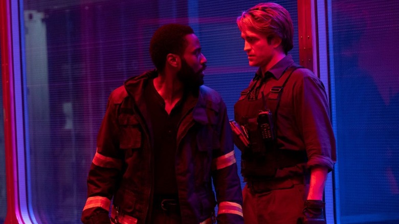 John David Washington as The Protagonist and Robert Pattinson as Neil as time travel boyfriends who share a moment in Tenet
