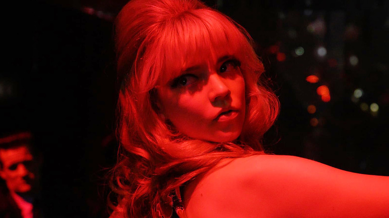 Sandie dancing while bathed in red light in Last Night in Soho