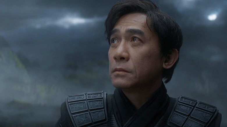 Tony Leung as Xu Wenwu looking up at a stormy sky in Shang-Chi and the Legend of the Ten Rings