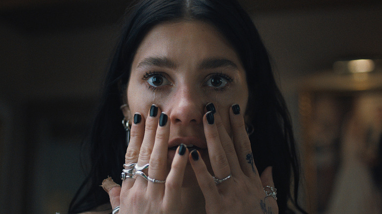 Rachel (Camila Morrone) holding her face on "Something Very Bad Is Going to Happen."