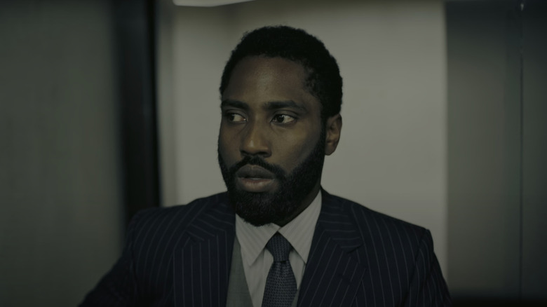 John David Washington's Protagonist looks nervous as he stands in a suit in Tenet