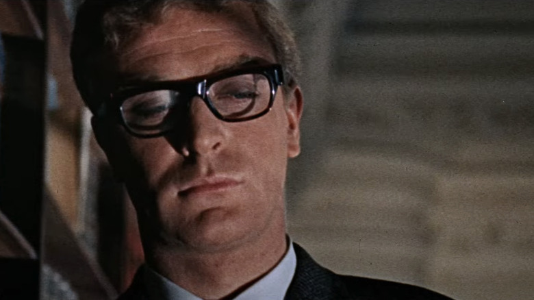Michael Caine's Harry Palmer looks down in closeup in The Ipcress File