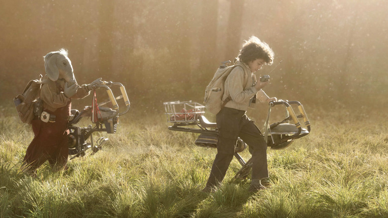 Neel and Wim pushing their speeder bikes through a grassy field on At Attin in Star Wars: Skeleton Crew