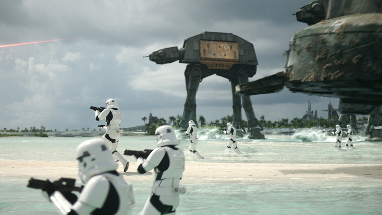 Stormtroopers and AT-ATs fighting rebels on Scarif in Rogue One: A Star Wars Story