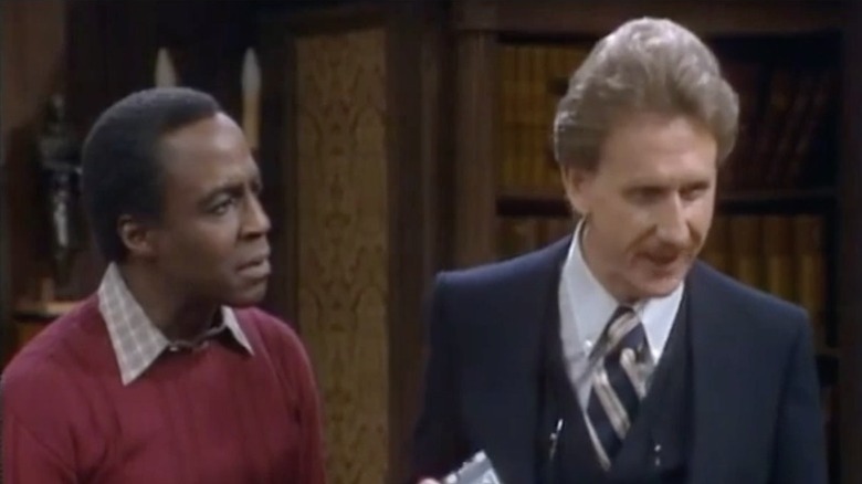 Benson next to Clayton Endicott III in a law office on Benson