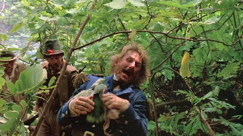 Major Siegfried Henningson freaking out over a parrot on his chest while in the jungle, a scene from Walker
