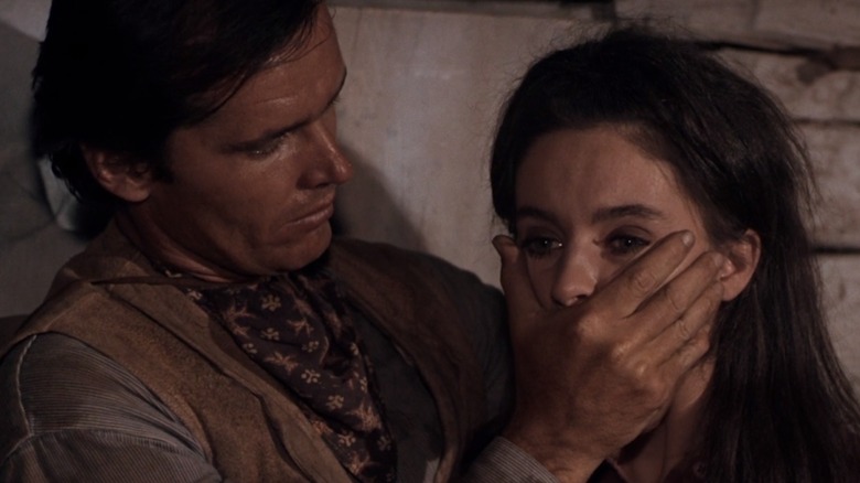 Jack Nicholson as Wes places his hand over the mouth of Millie Perkins as Abigail in Ride with the Whirlwind