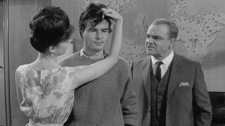 James Cagney sneers as C.R. MacNamera while Pamela Tiffin as Scarlett Hazeltine tousles the hair of Horst Bucholz as Otto Ludwig Piffl in One, Two, Three