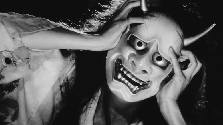 Nobuko Otowa as the older woman dons a demon mask in Onibaba