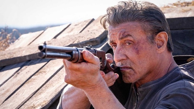 Sylvester Stallone takes aim with a rifle as John Rambo in Rambo: Last Blood