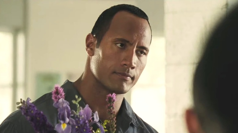 Dwayne Johnson as Sean Porter, holding flowers in Gridiron Gang