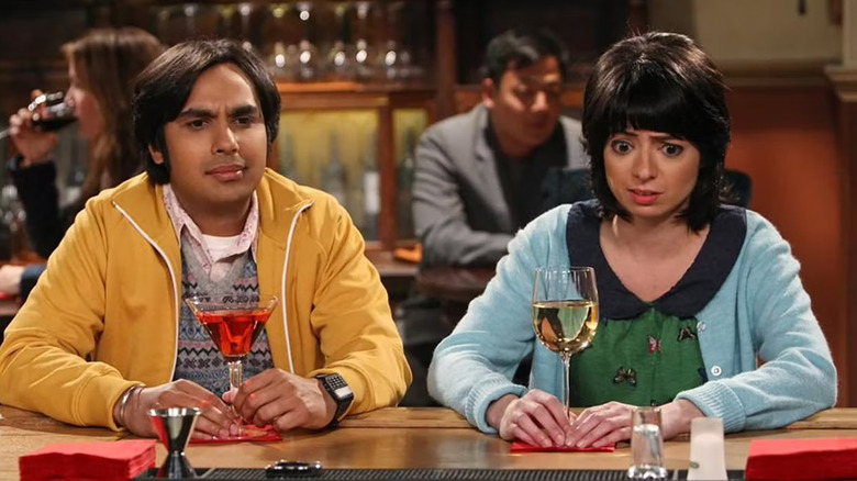 Raj and Lucy looking confused at a bar with their drinks on The Big Bang Theory