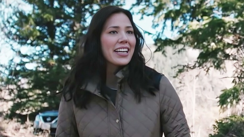 Sarah Nyugen standing in front of a free on 'Yellowstone'
