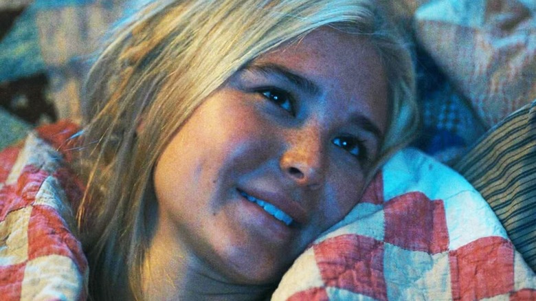 Elsa lying down and smiling on '1883'