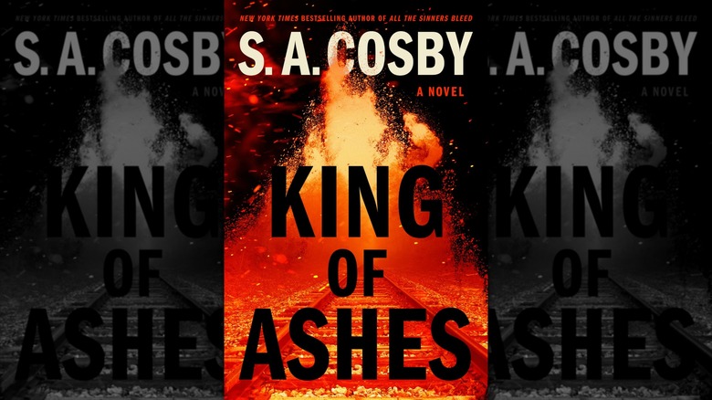 An image of the cover of King of Ashes by S. A. Cosby, depicting a train track engulfed in flames.