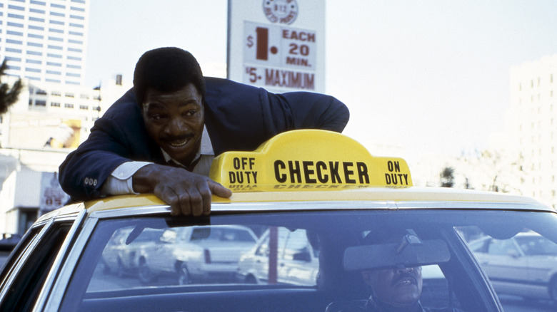 Carl Weathers surfing a taxi
