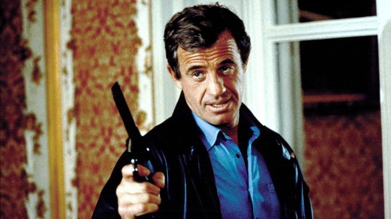 Jean-Paul Belmondo raising a gun