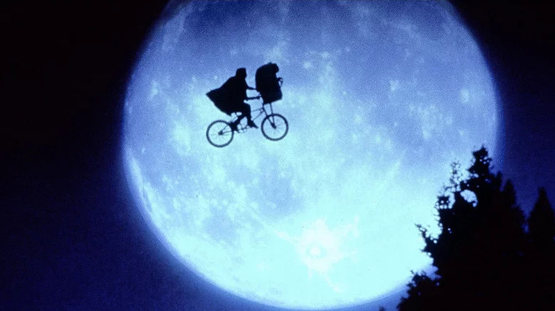 Elliott Taylor (Henry Thomas) and E.T. fly their bicycle across a full moon in E.T. the Extra-Terrestrial